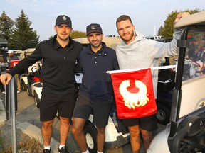 Nazem Kadri, centre, pictured with MacKenzie Weegar, left, and Jonathan Huberdeau at a Flames charity golf tournament on Sept. 14.