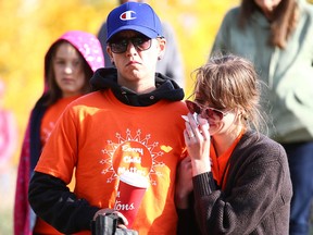 Participants console each other during Orange Shirt Day ceremonies on the second National Day for Truth and Reconciliation at Fort Calgary on Friday.