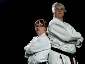 Natalie Olson, left, the first Canadian with Down Syndrome to achieve her black belt in karate, is pictured with her trainer Heather Fidyk.  Olson is a member of the South Calgary Wado Kai Karate Club, which has won the Perry Cavanagh Award for Athletic Leadership from Sport Calgary.