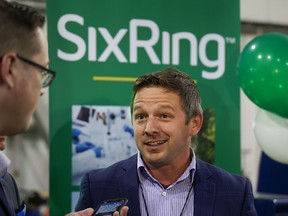 Francis Drouin, Parliamentary Secretary to the Minister of Agriculture and Agri-Food, speaks with media after announcing funding for SixRing Inc. in Calgary on Tuesday.
