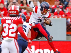 Quarterback Vernon Adams Jr., then with the Montreal Alouettes, leaps in for a touchdown against the Calgary Stampeders at McMahon Stadium in Calgary on June 9, 2022.