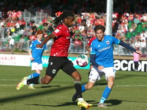 Cavalry FC's Ali Musse gets a foot on a cross in front of Atletico Ottawa's Maxim Tissot during CPL soccer action on ATCO Field at Spruce Meadows in Calgary on Saturday. Ottawa won 3-1.