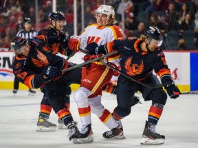 Calgary Wranglers defenceman Jeremie Poirier battles the Coachella Valley Firebirds during the Wranglers’ first AHL game, at Scotiabank Saddledome on Sunday, Oct. 16, 2022. Poirier scored the club’s first goal.
