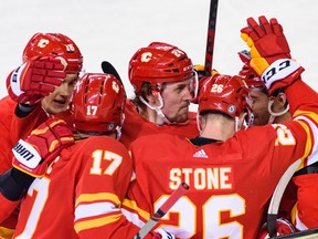 The Calgary Flames celebrate a goal by defenceman Michael Stone during a 4-1 win over the Pittsburgh Penguins at Scotiabank Saddledome in Calgary on Tuesday, Oct. 25, 2022.