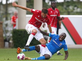Cavalry Charlie Trafford and Ottawa Abdou Sissoko battle for a loose ball during CPL soccer action between Athletico Ottawa and Cavalry FC on ATCO Field at Spruce Meadows in Calgary on Sunday, August 21, 2022. Jim Wells/Postmedia