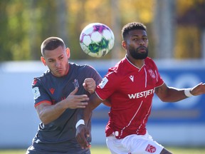 Forge Rezart Rama and Cavalry Mikaël Cantave go for a loose ball during CPL semi final leg 1 action between Cavalry FC and Forge FC on ATCO Field at Spruce Meadows in Calgary on Saturday , October 15, 2022. Jim Wells/Postmedia