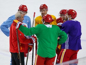 Calgary Flames head coach Darryl Sutter chats with players on the ice at the end of practice on Wednesday, October 12, 2022. The Flames’ first regular season game goes on Thursday against the 2022 Stanley Cup winning Colorado Avalanche.