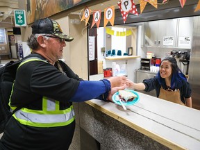 Mustard Seed staff member TJ serves Ron some pie and coffee at the agency’s downtown Neighbour Centre on Thanksgiving Monday, October 10, 2022. A full Thanksgiving dinner was also offered at the Foothills Shelter.
Gavin Young/Postmedia.