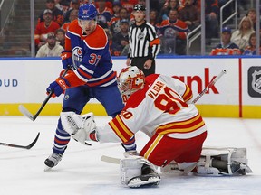 Oct 15, 2022; Edmonton, Alberta, CAN; Calgary Flames goaltender Dan Vladar (80) makes a save while Edmonton Oilers forward Warren Foegele (37) looks for a rebound during the first period at Rogers Place.