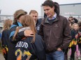 Prime Minister Justin Trudeau talks with an individual from the Port Aux Basques U13 girls hockey team in the aftermath of Hurricane Fiona in Port Aux Basques, Newfoundland and Labrador, Sept. 28, 2022.