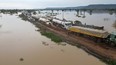 Flood water, breaking a bank, floods a road close to a river bank in Lokoja, Nigeria October 13, 2022.