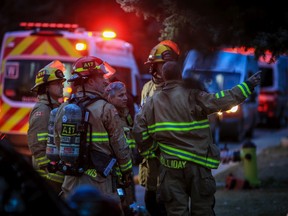 Calgary firefighters work at the scene of a fatal fire in Bowness on Thursday, October 20, 2022.