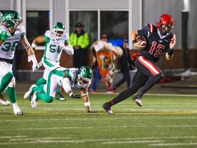 Calgary Stampeders quarterback Tommy Stevens outruns Saskatchewan Roughriders defenders during CFL action at McMahon Stadium on Saturday, October 29, 2022. 
Gavin Young/Postmedia. Calgary won the game 36-10.