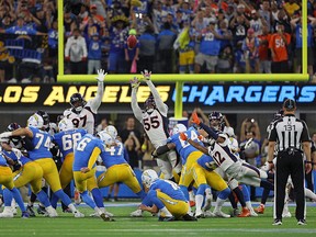 Dustin Hopkins of the Los Angeles Chargers kicks the game-winning field goal in overtime to defeat the Denver Broncos at SoFi Stadium on Monday. Deane Leonard recovered a fumble a few plays earlier, leading to the win.