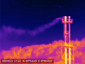 FILE PHOTO: A handout screen grab from thermographic video footage shot on April 18, 2021, with an infrared camera and made available to Reuters on June 10, 2021 by Clean Air Task Force (CATF), shows what appears to be methane gas leaking from two stacks at SNAM's Panigaglia LNG terminal near La Spezia, Italy.