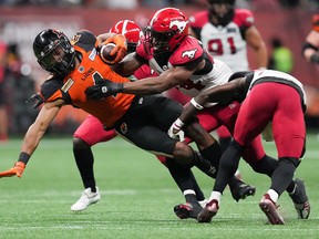 The Calgary Stampeders’ Silas Stewart (44) tackles the B.C. Lions’ Keon Hatcher at BC Place in Vancouver on Sept. 24, 2022.