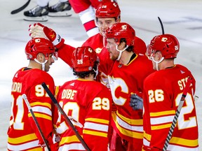 Calgary Flames forward Brett Ritchie celebrates with teammates after scoring against the Carolina Hurricanes at the Scotiabank Saddledome in Calgary on Saturday, Oct. 22, 2022.