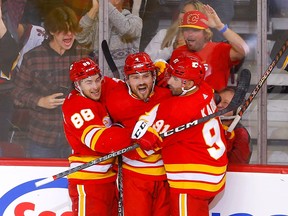 Calgary Flames defenceman Rasmus Andersson (centre), pictured celebrating his goal with forwards Andrew Mangiapane (left) and Nazem Kadri against the Colorado Avalanche on Oct. 13, 2022, has seven points, including six assists, in six games so far this season.
