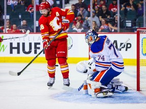 Sep 28, 2022; Calgary, Alberta, CAN; Calgary Flames centre Elias Lindholm (28) screens in front of Edmonton Oilers goaltender Stuart Skinner (74) during the third period at Scotiabank Saddledome.