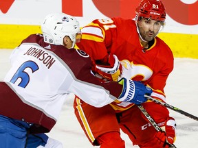 Calgary Flames Nazem Kadri battles against Erik Johnson of the Colorado Avalanche on Oct. 13.