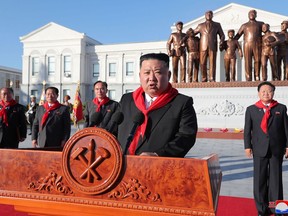 This picture taken on October 12, 2022 shows North Korean leader Kim Jong Un taking part in a ceremony to mark the 75th anniversaries of the founding of Mangyongdae Revolutionary School and Kang Pan Sok Revolutionary School.