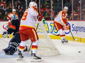 Calgary Wranglers forward Cole Schwindt (right) during a game against the Coachella Valley Firebirds at Scotiabank Saddledome in Calgary on Oct. 16, 2022.