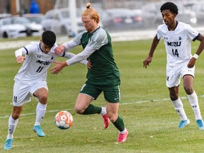 MRU Cougars David Schaefer left, against UFV Cascades Taylor Richardson during the first half of the Canada West men's soccer quarterfinals in Mount Royal Stadium Field on Saturday, October 29, 2022.