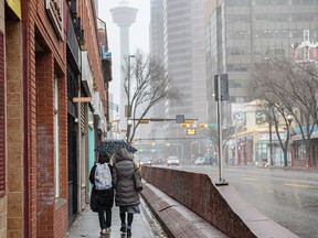 Umbrellas were out in full force on Tuesday as snow began to fall in downtown Calgary.