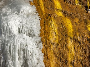 Ice and yellow and green algae on the rocks of a spring in the Kananaskis River valley southwest of Calgary, Ab., on Tuesday, November 15, 2022.
