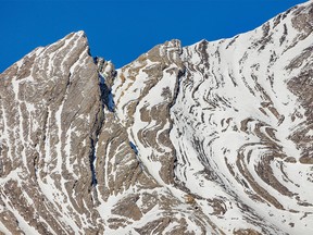 Folds and twists highlighted by snow in the rocks of Storm Mountain near Highwood Pass southwest of Calgary, Ab., on Tuesday, November 15, 2022.