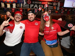 Canadian soccer fans, left to right, Andrew Chappell, Brent Tebin, and Megan DeVetten gather at the Ship & Anchor in Calgary on Wednesday, November 23, 2022 to watch Canada's first World Cup match in Qatar against Belgium.