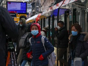 Transit riders at a CTrain station in downtown Calgary on Wednesday, March 9, 2022.
