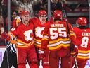 CALGARY, CANADA - NOVEMBER 12: Trevor Lewis #22 (L) of the Calgary Flames celebrates with his teammates after scoring against the Winnipeg Jets during the second period of an NHL game at Scotiabank Saddledome on November 12, 2022 in Calgary, Alberta, Canada.