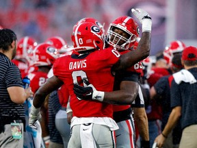 ATHENS, GEORGIA - NOVEMBER 05: Rian Davis #0 and Sedrick Van Pran #63 of the Georgia Bulldogs react after a play against the Tennessee Volunteers during the fourth quarter at Sanford Stadium on November 05, 2022 in Athens, Georgia.
