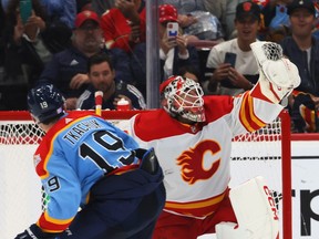Calgary Flames goaltender Jacob Markstrom makes a save on Florida Panthers forward Matthew Tkachuk in a shootout at FLA Live Arena in Sunrise, Fla., on Saturday, Nov. 19, 2022. The Flames won 5-4.
