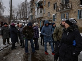 Members of public queue for food on November 22, 2022 in Horenka, Ukraine.