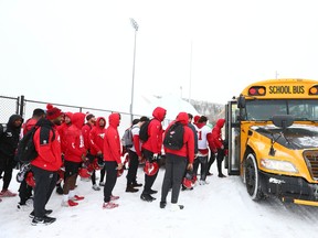 Calgary Stampeders players line up to board a bus after practice in Calgary on Wednesday, November 2, 2022. The team practised indoors at the new inflatable dome at the Shouldice Athletic Park.