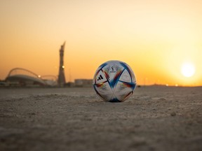 In this photo illustration, the official match ball of FIFA World Cup Qatar is seen in front of Khalifa International Stadium at sunset ahead of the FIFA World Cup Qatar 2022 on Nov. 16, 2022 in Doha, Qatar.