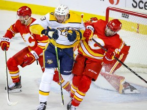 Nashville Predators forward Yakov Trenin and Calgary Flames forward Nazem Kadri collide at Scotiabank Saddledome in Calgary on Thursday, Nov. 3, 2022.