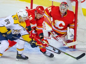 Calgary Flames goaltender Jacob Markstrom guards the net as Calgary Flames defenceman Nikita Zadorov and Nashville Predators forward Tanner Jeannot battle for the puck at Scotiabank Saddledome in Calgary on Thursday, Nov. 3, 2022.