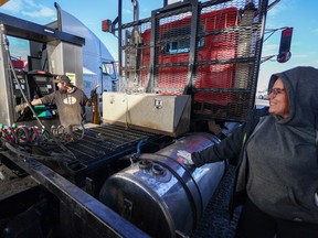 Jordan Hazelwood, left and Lyndsie McCann fill up their semi truck at the Road King truck stop in Calgary on Monday, November 14, 2022. Record high diesel prices have been seen across the country.