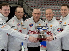 Team Canada members, from left, alternate Nathan Young, lead Geoff Walker, second E.J. Harnden, vice-skip Mark Nichols and skip Brad Gushue hold the trophy after capturing the Pan Continental Curling Championships men’s title at the WinSport Event Centre in Calgary on Sunday, Nov. 6, 2022.