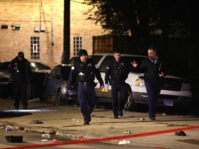Police investigate the scene where many people were reported to have been shot on October 31, 2022 in Chicago, Illinois.