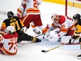 Calgary Flames goaltender Dan Vladar covers the puck as Pittsburgh Penguins forward Evgeni Malkin and Flames forward Tyler Toffoli collide at PPG Paints Arena in Pittsburgh on Wednesday, Nov. 23, 2022.