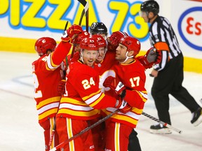 Calgary Flames forward Brett Ritchie (24) celebrates with teammates after scoring a goal against the Colorado Avalanche at Scotiabank Saddledome in Calgary on Oct. 13, 2022.