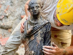 This photo handout on Nov. 8, 2022 by the Italian Culture Ministry shows a statue where more than 20 bronze statues where discovered in the mud of hot springs at the sanctuary of San Casciano dei Bagni, Tuscany.
