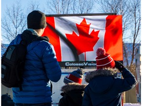 Calgarians watch the ceremony at the Military Museums during Remembrance Day in Calgary on Friday.