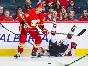 Nikita Zadorov topples New Jersey Devils forward Nico Hischier.