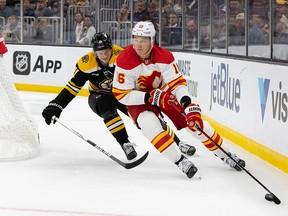Nikita Zadorov eludes Boston Bruins forward Trent Frederic on Nov. 10.