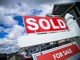 A file photo shows a for sale sign outside of a home.